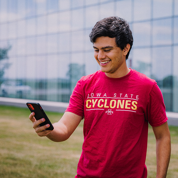An ISU student stands in front of the Student Innovation center