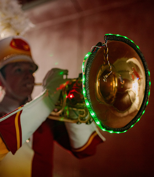An ISU band member displays colorful lights on their instrument