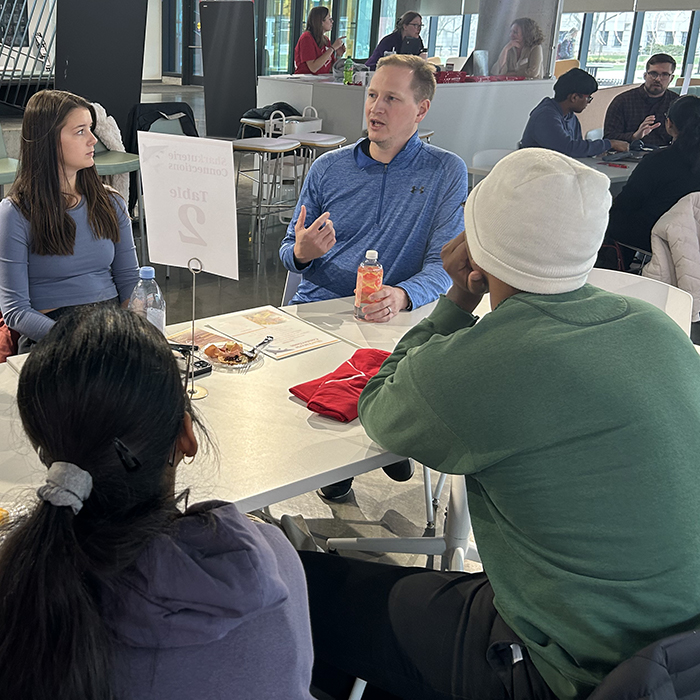 A group of students and employers meet each other at a networking event